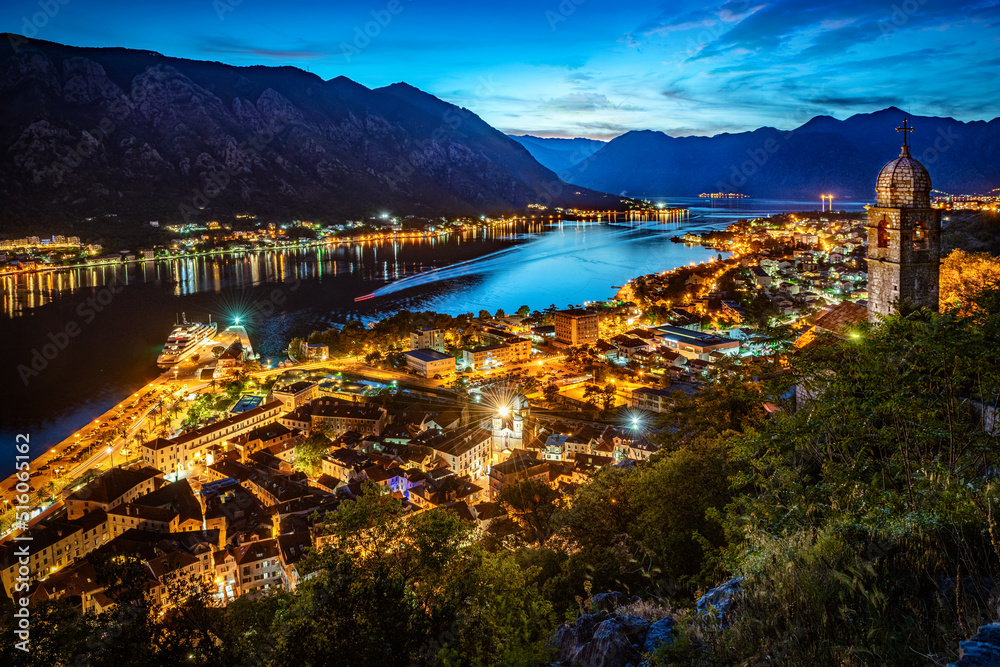 Fototapeta premium Panoramic evening view of the church, the old town and the Bay of Kotor from above. The Bay of Kotor is the beautiful place on the Adriatic Sea. Kotor, Montenegro.
