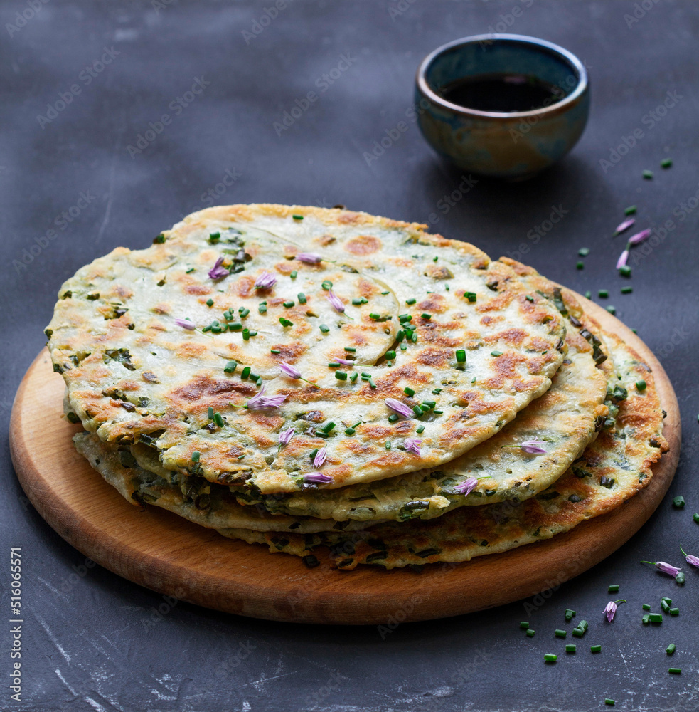 Homemade appetizing scallion pancakes served with soy sauce.