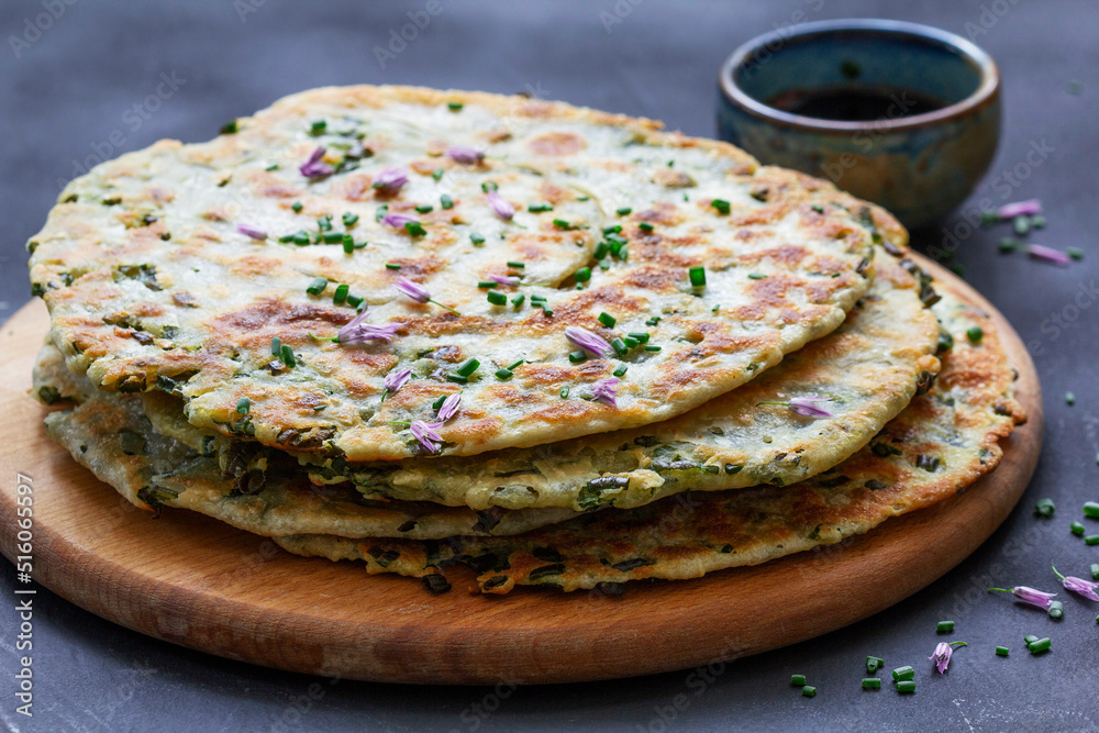 Homemade appetizing scallion pancakes served with soy sauce.