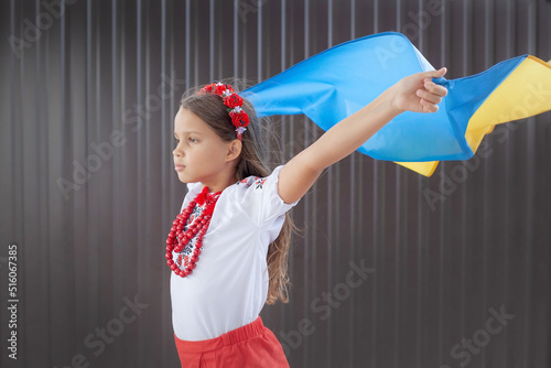 girl looks into the distance raising the flag of Ukraine. High quality photo