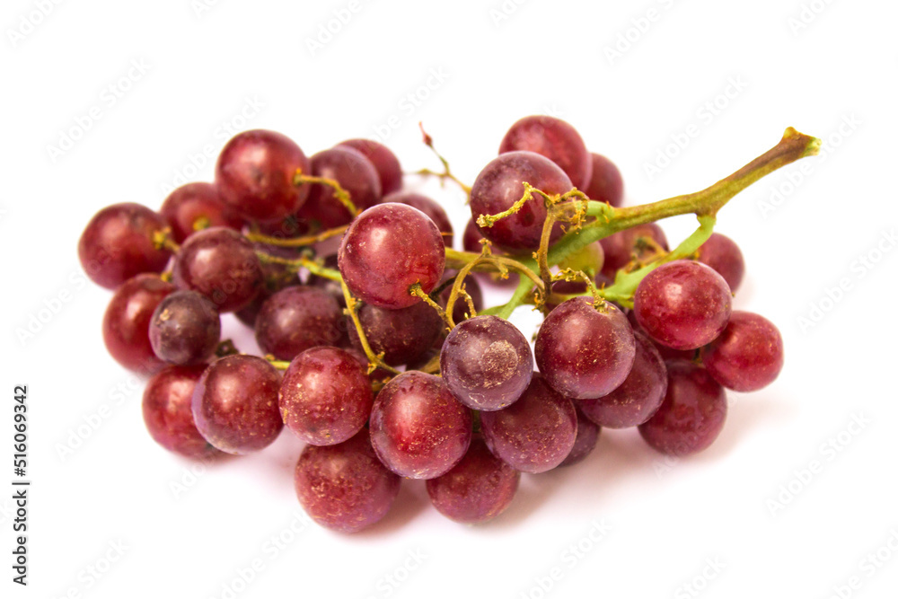 red grapes lie on a white background
