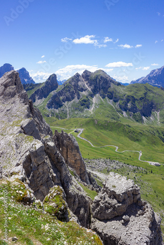 Mountain summer landscape. Grassy meadows and rocks under the blue sky. Aerial view on Passo Giau, Italy. Concept of tourism and responsible vacation. High quality image.