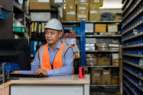 Asian man worker working in warehouse. Industrial and industrial workers concept. worker Man order details and checking goods and Supplies.
