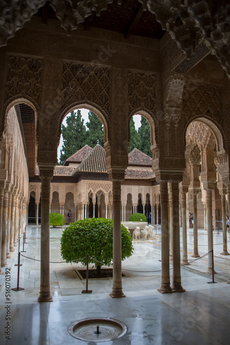 View at the Patio at the Lions, twelve marble lions fountain on Palace of the Lions or Harem, Alhambra citadel, tourist people visiting photo