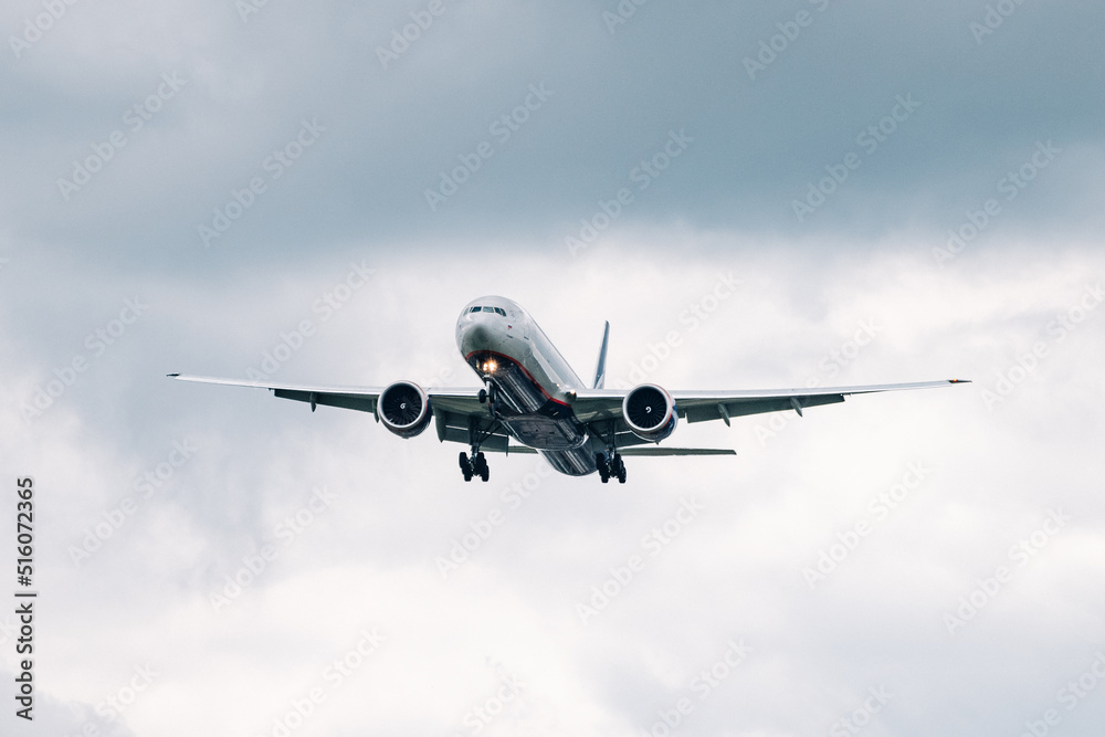 Passenger plane comes in for landing in cloudy weather. Passenger plane comes in for landing in cloudy weather.