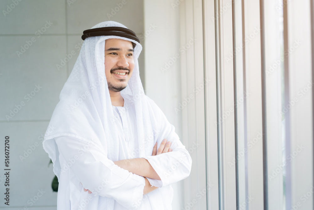 close up front view portrait of arabian businessman smile and arm crossed in office room for leadership concept