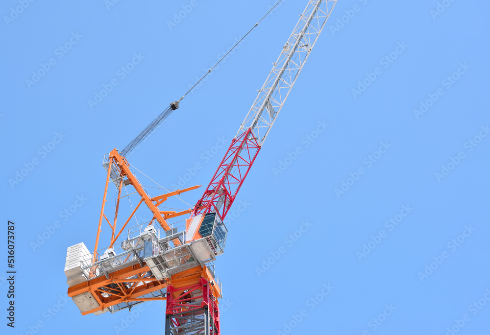 Closeup construction crane against blue sky