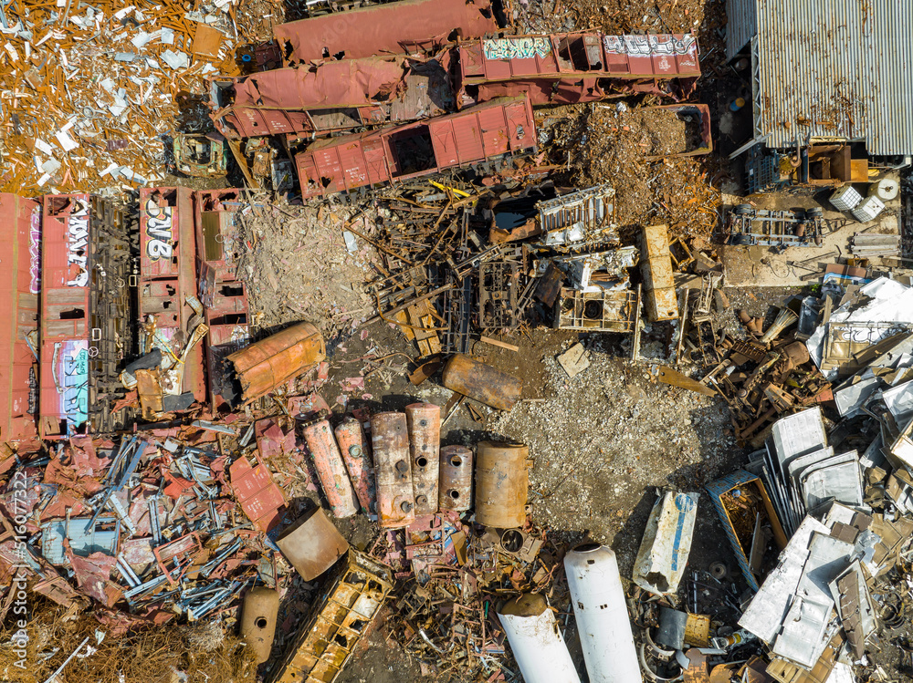 Scrap Metal Recycling. Aerial View of Industrial Scrap Processing. Junkyard Background. Metal, aluminum, copper. Recycling with heavy equipment. Scrap Metal Recycling. Aerial View of Industrial Scrap Processing. Junkyard Background. Metal, aluminum, copper. Recycling with heavy equipment.