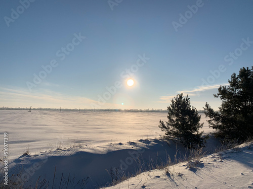 Peaceful sunrise at snowy field