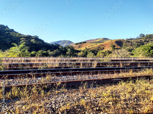 Landscape showing train tracks with some bush and mountains and hills in the city of Itabira Minas Gerais Brazil