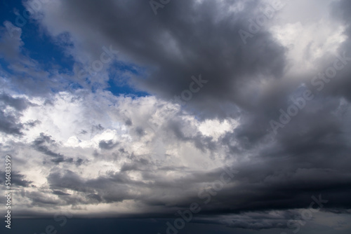 Storm cloudy epic dramatic sky with cumulus dark and white clouds and blue sky background texture, thunderstorm, heaven 