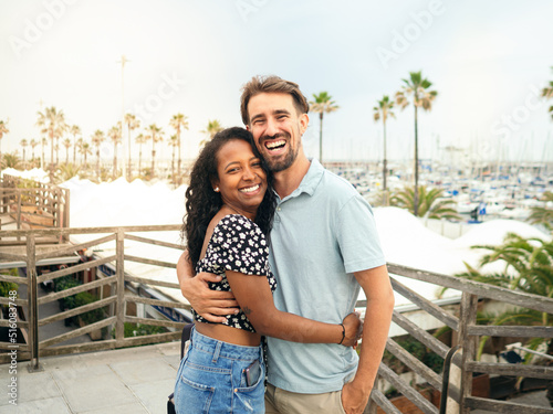 Happy diverse smiling heterosexual young couple looking at camera during vacation. happy couple,honeymoon,vacation