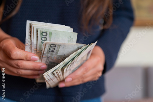 Fotografia the girl holds in her hands banknotes money polish zlotys and pennies coins sala