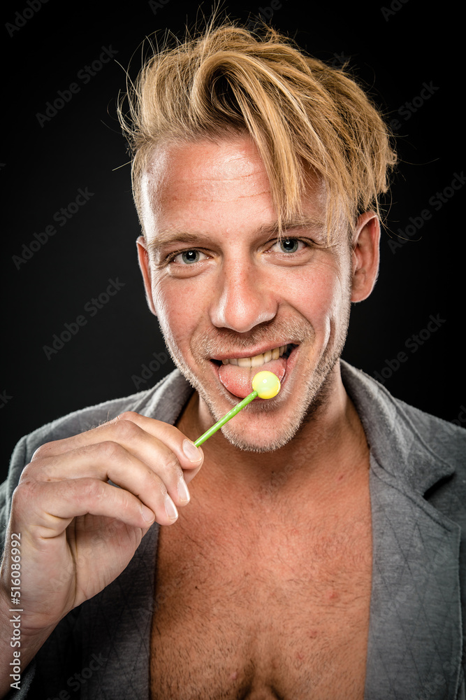 Strange Man Lick Lollipop With His Tongue And Smile Cheeky And Naughty At Camera With Sassy Face