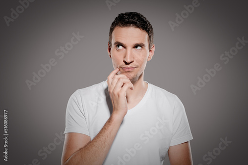 mull man in thoughts think about evaluation and has an idea while show his expression isolated on gray background