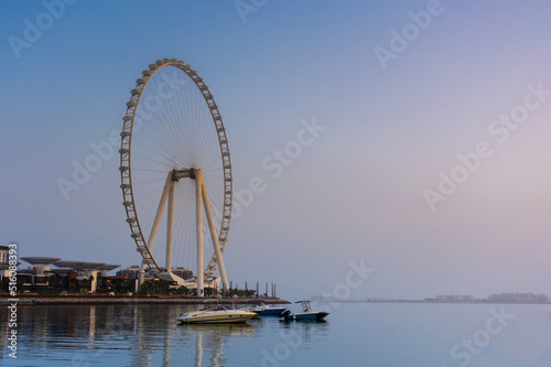 The coast of Dubai, sea yachts on the background of the Ferris wheel