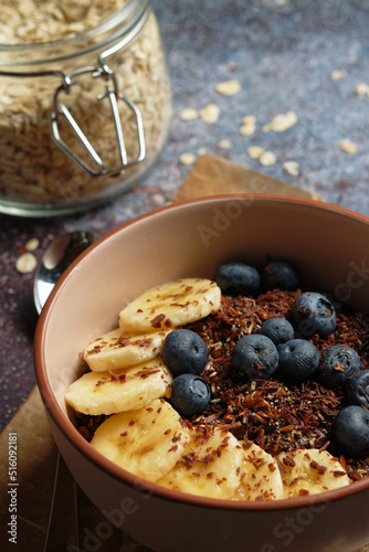 Chocolate banana oatmeal, with ground flaxseed and blueberries