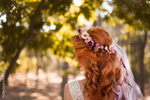 Bridal hair detail decorated with colorful flowers.Wedding photo