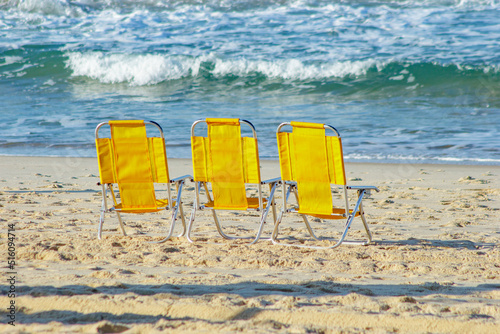 yellow beach chair at leblon beach in Rio de Janeiro, Brazil.