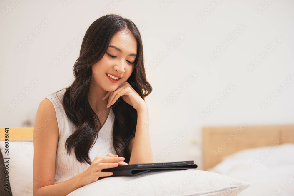 Asian girl using tablet playing game and social media or chatting with her friends. Asian girl using tablet playing game and social media or chatting with her friends.