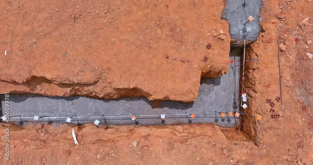 Foundation of a house under construction with building a strip reinforcement frame for construction site Foundation of a house under construction with building a strip reinforcement frame for construction site