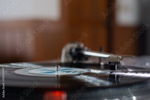 The Headshell Cartridge and Stylus of Classic Vintage Vinyl Record Player Playing on Vinyl Record Music photo