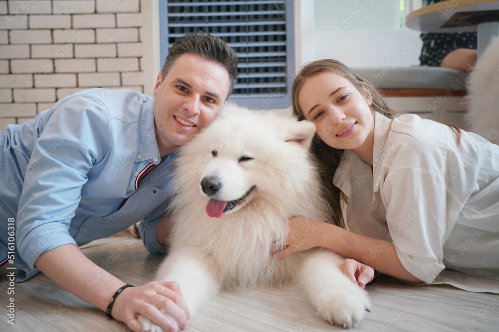 Happy laughing adult man lying on wooden floor. Bald male emotions. Guy with his siberian husky dog at home. Love animals. Domestic mammal puppy licking owner ear. Funny expressive leisure time. Happy laughing adult man lying on wooden floor. Bald male emotions. Guy with his siberian husky dog at home. Love animals. Domestic mammal puppy licking owner ear. Funny expressive leisure time.