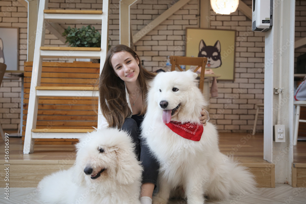 beautiful woman hugging her adorable golden retriever dog at home. love for animals concept. lifestyle indoors