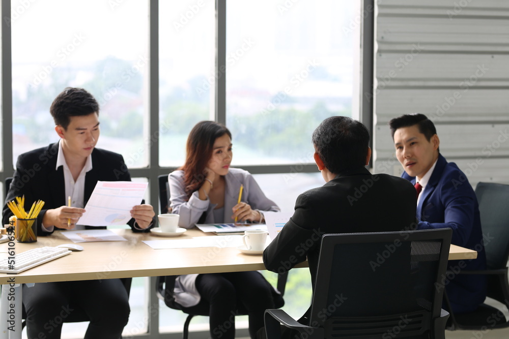 Businessman Giving Speech On Business Meeting With Colleagues, Discussing Work Ideas And Projects, Making Presentation Standing In Modern Office. Teamwork, Entrepreneurship, Corporate Meeting Businessman Giving Speech On Business Meeting With Colleagues, Discussing Work Ideas And Projects, Making Presentation Standing In Modern Office. Teamwork, Entrepreneurship, Corporate Meeting