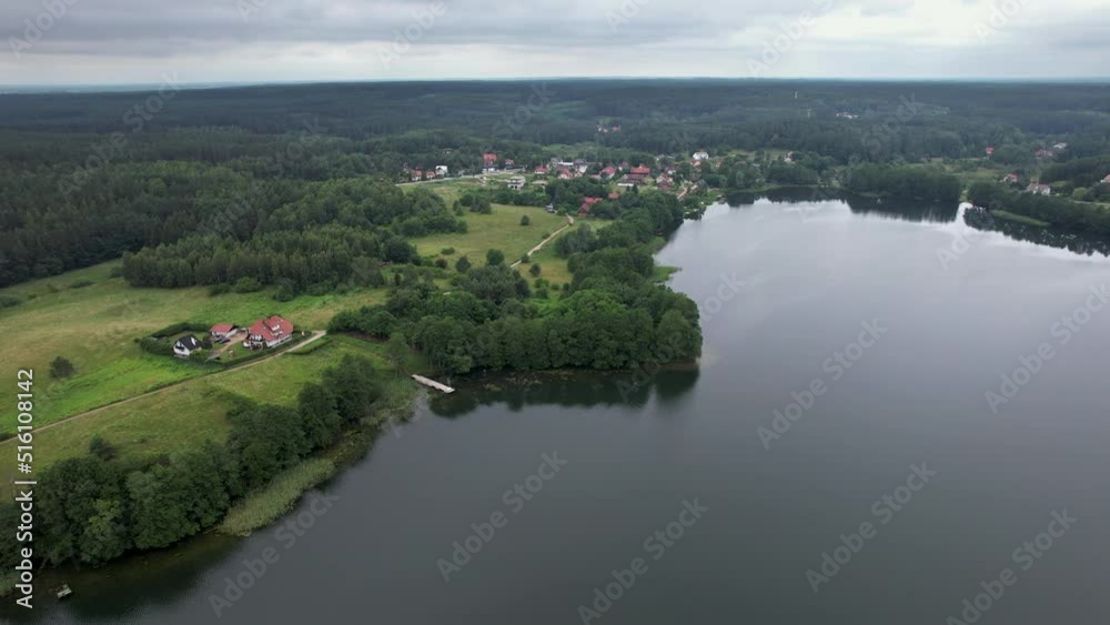 Spectacular Beautiful Lake Aerial View in Poland Village. Countryside with Woods and Lake in Europe. Dramatic Aerial View of Big Lake and Green Forest. Epic Amazing Nature Landscape Nature Reserve.