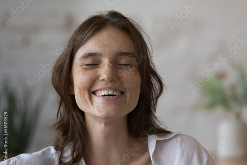 Bild auf Leinwand Close up shot happy freckled woman laughing with eyes closed