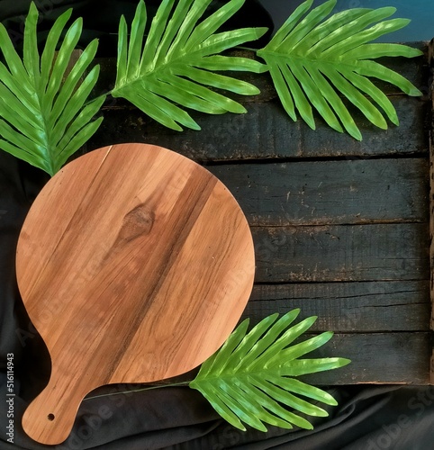 kitchen utensils with leaves on black background 