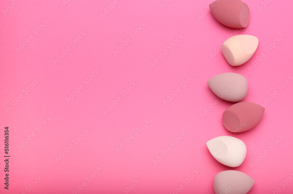 sponges for makeup on a pink background. Beauty concept, top view, space for text