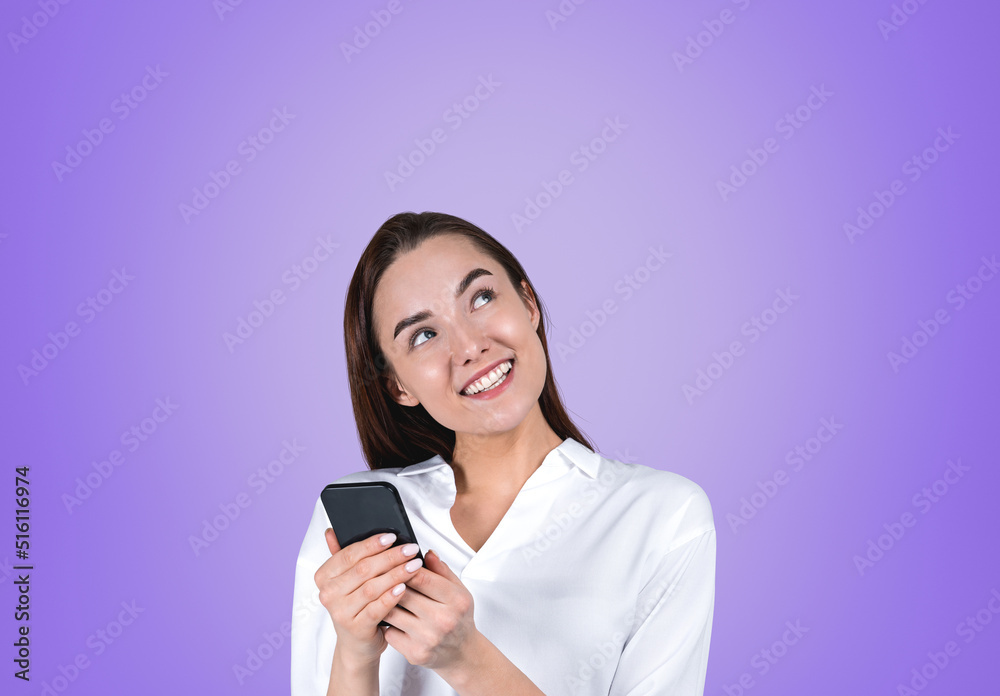 Happy businesswoman with smartphone in hands on violet backgroun