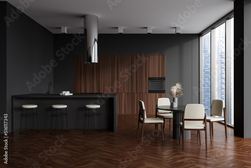 Kitchen interior with countertop and dining table with chairs, panoramic window