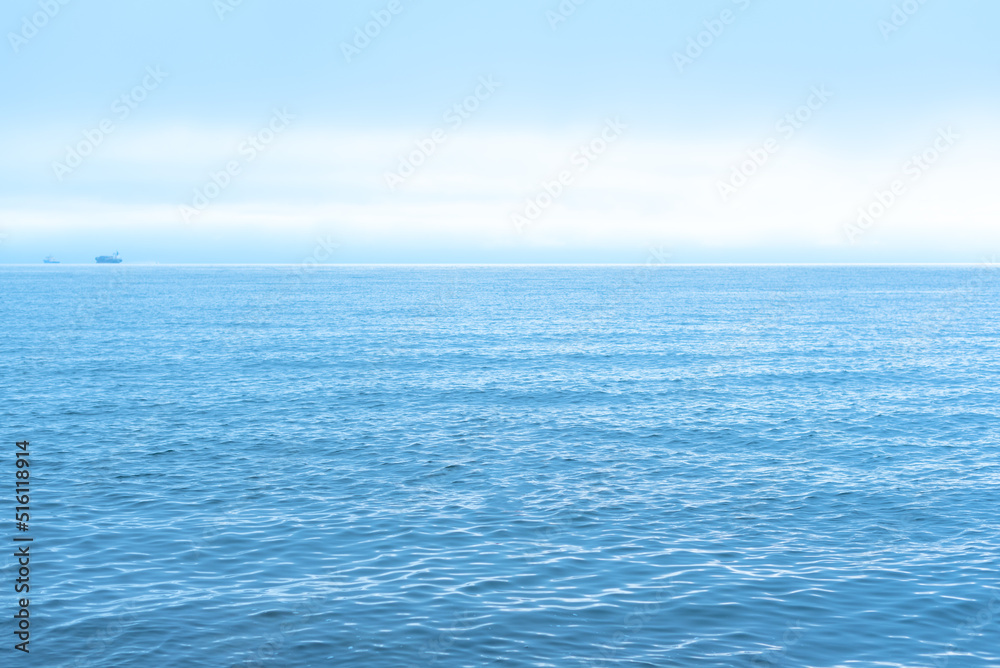 Nature background with blue sea against cloudy sky