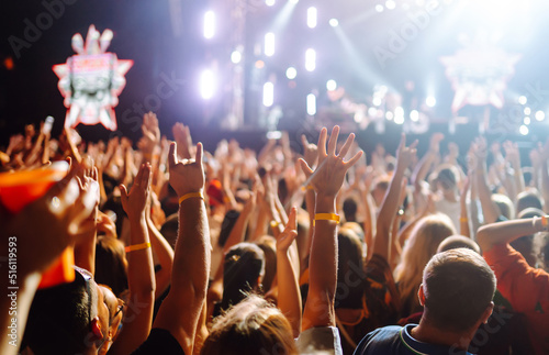 Crowd raising their hands, dancing and enjoying great the concert. Summer holiday, vacation 
