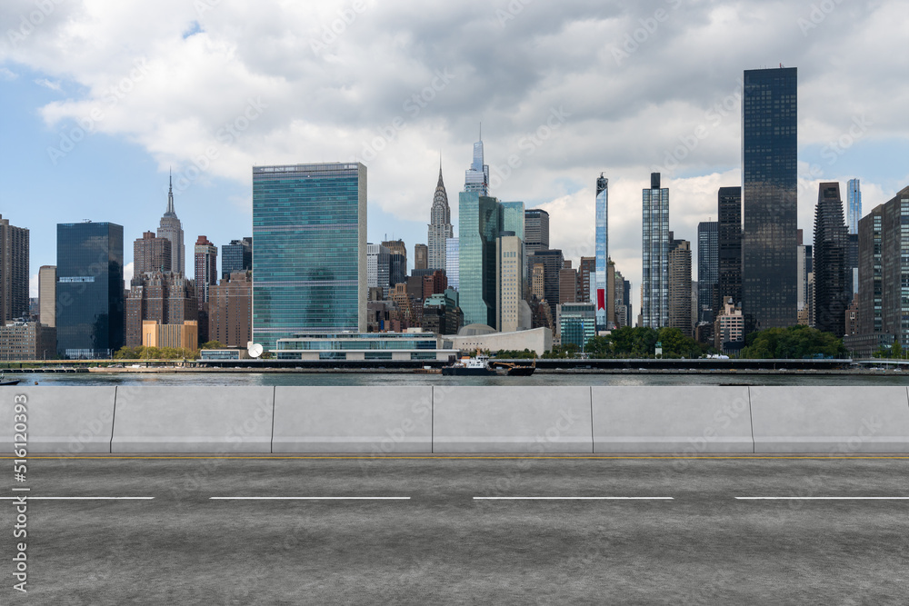 Fototapeta premium Empty urban asphalt road exterior with city buildings background. New modern highway concrete construction. Concept of way to success. Transportation logistic industry fast delivery. New York. USA.