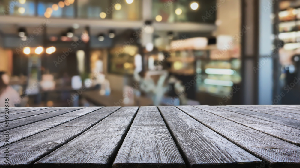 Empty wood table top and blurred coffee shop and restaurant interior background - can used for display or montage your products. Empty wood table top and blurred coffee shop and restaurant interior background - can used for display or montage your products.