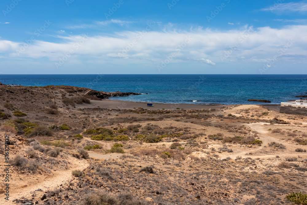 Panoramic sea view on Abades beach in Poris de Abona on the east coast of Tenerife, Canary Islands, Spain. Hiking trail leading to a pebble beach in a remote holiday resort. Sunny day, summer vacation Panoramic sea view on Abades beach in Poris de Abona on the east coast of Tenerife, Canary Islands, Spain. Hiking trail leading to a pebble beach in a remote holiday resort. Sunny day, summer vacation