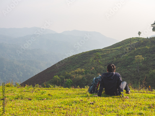 Trekking solo backpack on mountain trail in tropical forest at Tak Province, Thailand. © TongTa