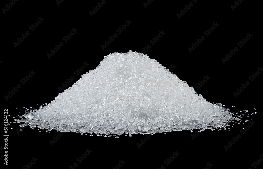 Pile of white salt on a black background. Crystals of sea salt.