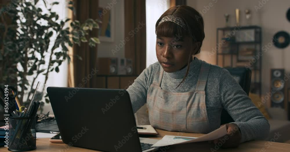 A young girl takes a break from work to write back overdue messages. The woman tries to use the time spent at desk productively and writes everything down so as not to forget anything. A young girl takes a break from work to write back overdue messages. The woman tries to use the time spent at desk productively and writes everything down so as not to forget anything.