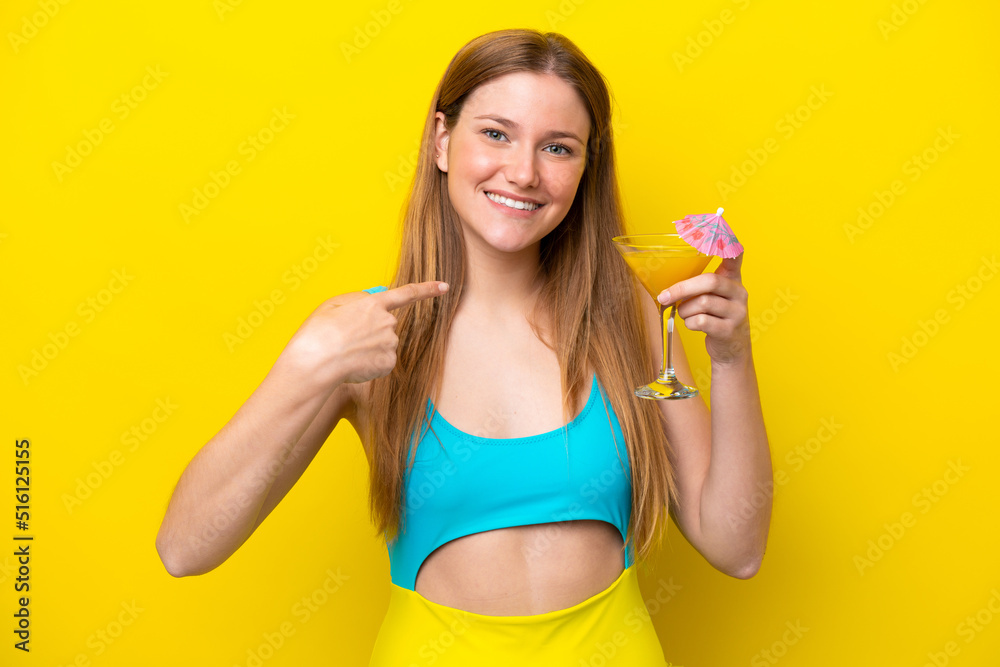 Young caucasian woman holding a cocktail isolated on yellow background with surprise facial expression Young caucasian woman holding a cocktail isolated on yellow background with surprise facial expression