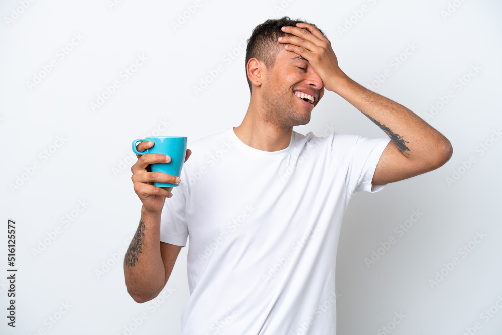 Young Brazilian man holding cup of coffee isolated on white background has realized something and intending the solution Young Brazilian man holding cup of coffee isolated on white background has realized something and intending the solution