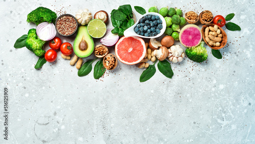 Healthy food background. Concept of Healthy Food  Fresh Vegetables  Nuts and Fruits. On a stone background. Top view. Copy space.