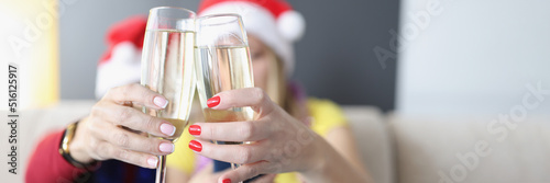 Women hold champagne drinks, glass filled with alcohol, raise toast for new year coming