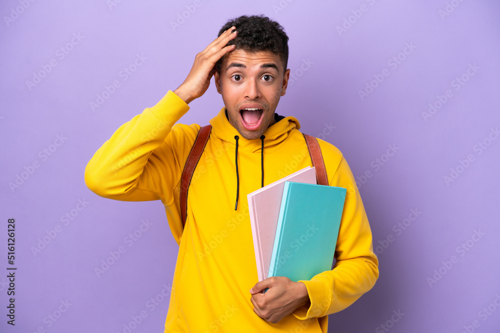 Young student Brazilian man isolated on purple background with surprise expression Young student Brazilian man isolated on purple background with surprise expression