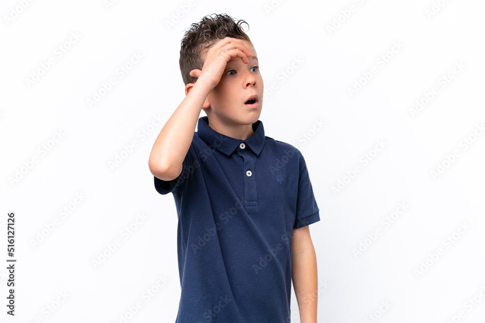 Little caucasian boy isolated on white background doing surprise gesture while looking to the side Little caucasian boy isolated on white background doing surprise gesture while looking to the side