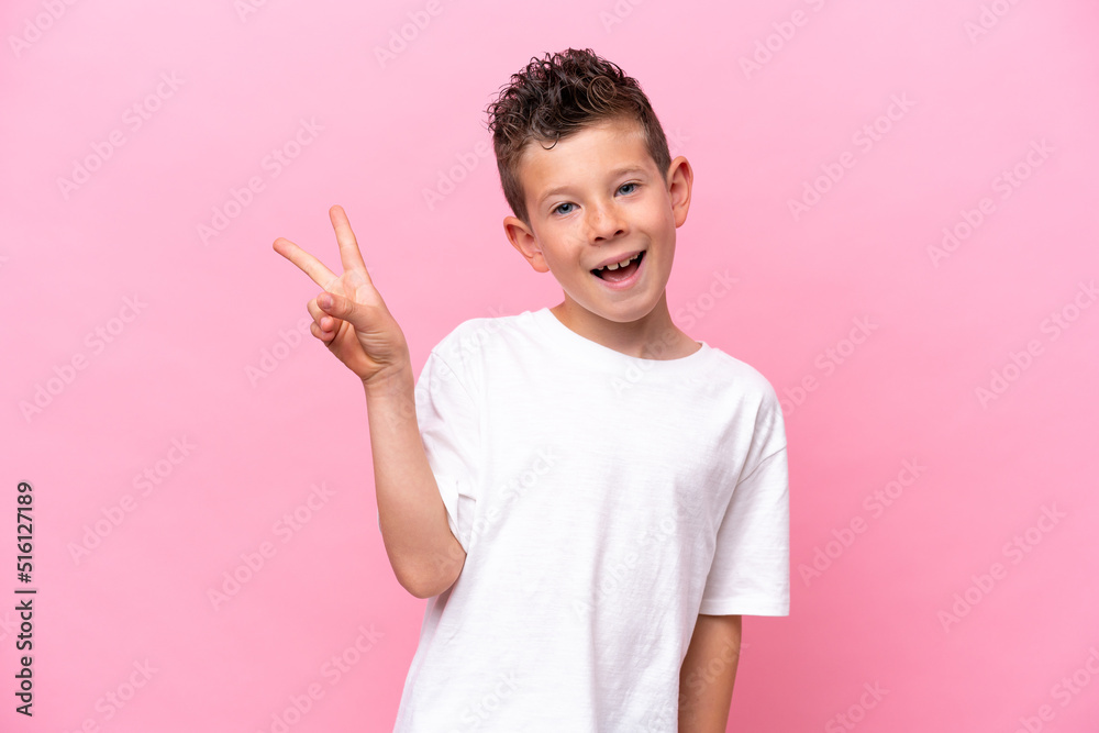 Little caucasian boy isolated on pink background smiling and showing victory sign Little caucasian boy isolated on pink background smiling and showing victory sign